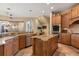Kitchen features stainless appliances, stone counters, and a large island with breakfast bar at 1010 Juliette Blvd, Mount Dora, FL 32757