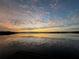 Beautiful lake sunset view with vibrant pink and orange clouds reflecting in the water at 1010 Juliette Blvd, Mount Dora, FL 32757