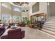 Stunning living room with high ceilings, clerestory windows, with seamless flow to the dining area at 1010 Juliette Blvd, Mount Dora, FL 32757