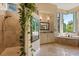 Bright main bathroom featuring a walk-in shower, vanity with a large mirror, and a garden view at 1010 Juliette Blvd, Mount Dora, FL 32757