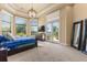 Spacious main bedroom with a cozy bed, large windows with scenic views, and access to the outdoors at 1010 Juliette Blvd, Mount Dora, FL 32757