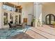 Outdoor patio with dining table, multiple doors, and a brick floor under a large lanai at 1010 Juliette Blvd, Mount Dora, FL 32757