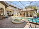 View of the pool and patio featuring a spa, brick pavers, landscaping, and stylish patio furniture at 1010 Juliette Blvd, Mount Dora, FL 32757