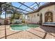 Enclosed pool and spa area with brick patio, landscaping, and outdoor furniture for relaxing and entertaining at 1010 Juliette Blvd, Mount Dora, FL 32757