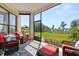 Relaxing screened porch with comfortable seating and a scenic backyard at 1010 Juliette Blvd, Mount Dora, FL 32757