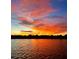 Beautiful sunset reflecting over the still lake water, showcasing vibrant colors at 1010 Juliette Blvd, Mount Dora, FL 32757