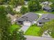 Aerial view showcasing a well-manicured lawn, and an attractive single-story home with grey driveway at 1113 Naples Dr, Orlando, FL 32804