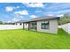 Rear view of a home with a covered patio, a fenced yard, and well-maintained landscaping at 1113 Naples Dr, Orlando, FL 32804