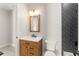 Charming bathroom featuring wood vanity, stylish mirror and black tiled shower at 1113 Naples Dr, Orlando, FL 32804