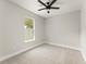 Well-lit bedroom with carpet flooring, a ceiling fan, and a large window at 1113 Naples Dr, Orlando, FL 32804