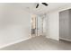 Cozy bedroom with neutral carpet, ceiling fan and a view to an ensuite bathroom at 1113 Naples Dr, Orlando, FL 32804
