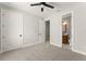 Bright bedroom with neutral walls and carpet, featuring a ceiling fan and ensuite bathroom access at 1113 Naples Dr, Orlando, FL 32804