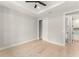 Spacious bedroom with a ceiling fan, light wood floors, and ensuite bath access at 1113 Naples Dr, Orlando, FL 32804
