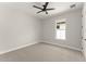 Bright, minimalist bedroom with carpet, window, and modern ceiling fan at 1113 Naples Dr, Orlando, FL 32804