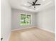A bright bedroom with tray ceiling, hardwood floors, and a large window at 1113 Naples Dr, Orlando, FL 32804