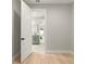 Bright and airy bedroom with white walls and light wood floors, leading to an ensuite bathroom at 1113 Naples Dr, Orlando, FL 32804