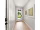 Inviting entryway with light wood floors, white walls, and a glass-paneled door opening to the front yard at 1113 Naples Dr, Orlando, FL 32804