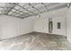 Clean two-car garage featuring exposed ceiling beams, white walls, and ample space at 1113 Naples Dr, Orlando, FL 32804