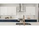 Modern kitchen with stainless steel appliances, white cabinets, and a designer backsplash at 1113 Naples Dr, Orlando, FL 32804