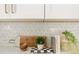 Close-up of kitchen backsplash showcasing designer tile and modern decor with white countertops at 1113 Naples Dr, Orlando, FL 32804