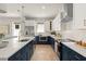 Stylish kitchen with stainless steel appliances, white uppers and blue lowers, plus a center island at 1113 Naples Dr, Orlando, FL 32804