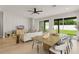 Open-concept living room featuring modern decor, designer accent wall, and sliding glass doors to backyard at 1113 Naples Dr, Orlando, FL 32804