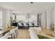 Open-concept living area with sleek kitchen island, stylish pendant lights, and modern furniture at 1113 Naples Dr, Orlando, FL 32804