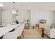 Open concept living area with modern kitchen, decorative wall, and wood flooring at 1113 Naples Dr, Orlando, FL 32804
