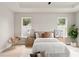 Bright bedroom with tray ceiling, light-colored walls, wood flooring, and dual windows at 1113 Naples Dr, Orlando, FL 32804