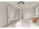 Bright bedroom with tray ceiling, light-colored walls, wood flooring, and multiple doors at 1113 Naples Dr, Orlando, FL 32804