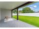 Covered patio overlooking a spacious, well-maintained lawn enclosed by a white privacy fence at 1113 Naples Dr, Orlando, FL 32804