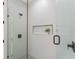 Sleek glass shower featuring horizontal tile and a built-in niche, complemented by matte black fixtures at 1113 Naples Dr, Orlando, FL 32804