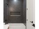 Modern shower with black herringbone tile, built-in niche, and rain shower head at 1113 Naples Dr, Orlando, FL 32804