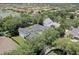 An aerial view displays a home with a screened pool in a picturesque neighborhood near a lake at 11721 Camden Park Dr, Windermere, FL 34786