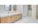 Stylish bathroom with double vanity, marble floors, and custom walk-in closet at 11721 Camden Park Dr, Windermere, FL 34786