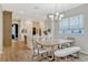 A bright dining area showcases elegant lighting, a natural wood table, and seamless flow to the kitchen at 11721 Camden Park Dr, Windermere, FL 34786