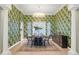 Sophisticated dining room with statement wallpaper, chandelier, and sleek display cabinet at 11721 Camden Park Dr, Windermere, FL 34786