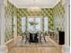 Elegant dining room featuring stylish wallpaper, chandelier, and modern furniture at 11721 Camden Park Dr, Windermere, FL 34786