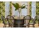 Tropical-themed dining room featuring unique wallpaper, stylish wood table, and white window shutters at 11721 Camden Park Dr, Windermere, FL 34786