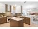 Spacious kitchen featuring a gas range, central island, stone countertops, and seamless dining area at 11721 Camden Park Dr, Windermere, FL 34786