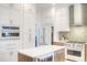 Bright kitchen showcasing white cabinetry, subway tile backsplash, and a center island with marble countertop at 11721 Camden Park Dr, Windermere, FL 34786