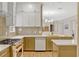 Well-lit kitchen boasts stainless steel appliances, custom cabinets, subway tile backsplash, and an island bar at 11721 Camden Park Dr, Windermere, FL 34786