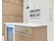 Kitchen island with wine fridge with white marble countertop and cabinets at 11721 Camden Park Dr, Windermere, FL 34786