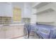 Laundry room with cabinets, shelving and a blue front-load washer and dryer at 11721 Camden Park Dr, Windermere, FL 34786
