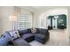 Comfortable living room featuring a grey sectional sofa and bright natural light at 11721 Camden Park Dr, Windermere, FL 34786