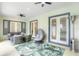 Covered patio with comfortable seating, ceiling fans, and a tropical-themed rug at 11721 Camden Park Dr, Windermere, FL 34786