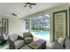 Covered patio with gray seating and a view of the screened-in pool area at 11721 Camden Park Dr, Windermere, FL 34786