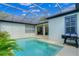 Backyard pool with screened enclosure, barbecue, and covered patio area at 11721 Camden Park Dr, Windermere, FL 34786