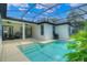 Backyard pool with screened enclosure, patio seating, and tropical landscaping at 11721 Camden Park Dr, Windermere, FL 34786