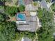 An aerial view of the property with a pool, backyard, and mature trees at 120 Springwood Trl, Altamonte Springs, FL 32714